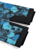 Two folded pant legs with blue and black abstract pattern on a white background