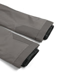 Roll of gray fabric with black trim on a white background