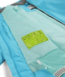 Close-up of a blue jacket with a green label on a white background