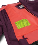 Inside of a purple jacket with a Pass Me On label