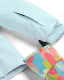 Light blue jacket with colorful floral patterned cuffs on a white background