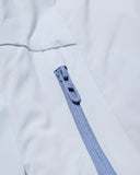 Close-up of a zipper on a light gray fabric background