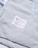 Close-up of a light gray jacket with a Spyder label on a white background