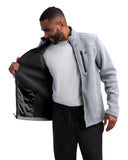 Man wearing a gray jacket with a black inner lining, holding the jacket open.