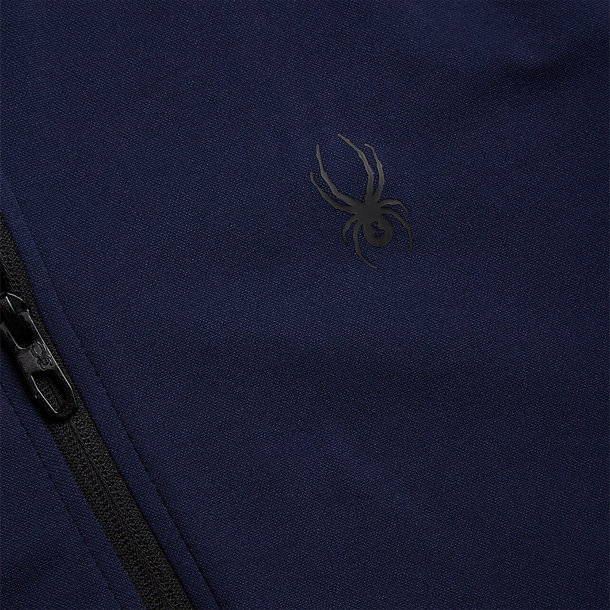 Navy blue fabric with a spider logo on a dark background