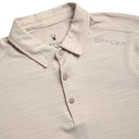 Close-up of a beige polo shirt with Spyder logo on collar and chest.