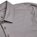 Close-up of a gray polo shirt with collar and buttons on a light gray background