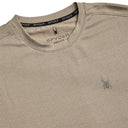 Close-up of a beige Spyder shirt with logo details on a white background