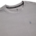Close-up of a gray Spyder athletic shirt with logo on a white background