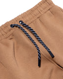 Close-up of brown pants with a drawstring on a white background
