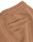 Close-up of brown pants with a pocket on a white background