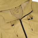 Close-up of a beige jacket with Spyder logo and branding