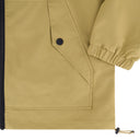 Close-up of a beige jacket with a button and drawstring detail.